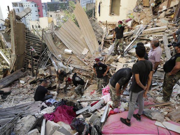 Lebanese soldiers search for survivors after a massive explosion in Beirut, Lebanon, Wednesday, Aug. 5, 2020. The explosion flattened much of a port and damaged buildings across Beirut, sending a giant mushroom cloud into the sky. In addition to those who died, more than 3,000 other people were injured, with bodies buried in the rubble, officials said.(AP Photo/Hassan Ammar)