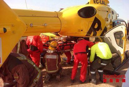 Los bomberos suben al herido  helic&oacute;ptero que lo llevar&aacute; a Bellvitge.