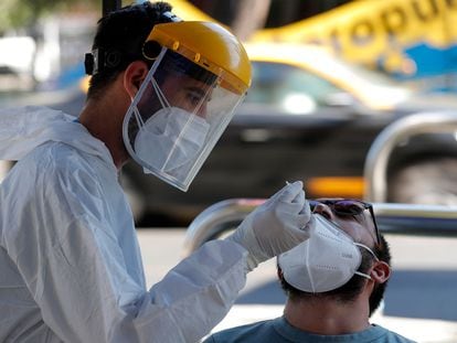 Un trabajador de la salud toma una muestra nasal para una prueba de PCR para detectar la covid-19 en las calles de Santiago, Chile.