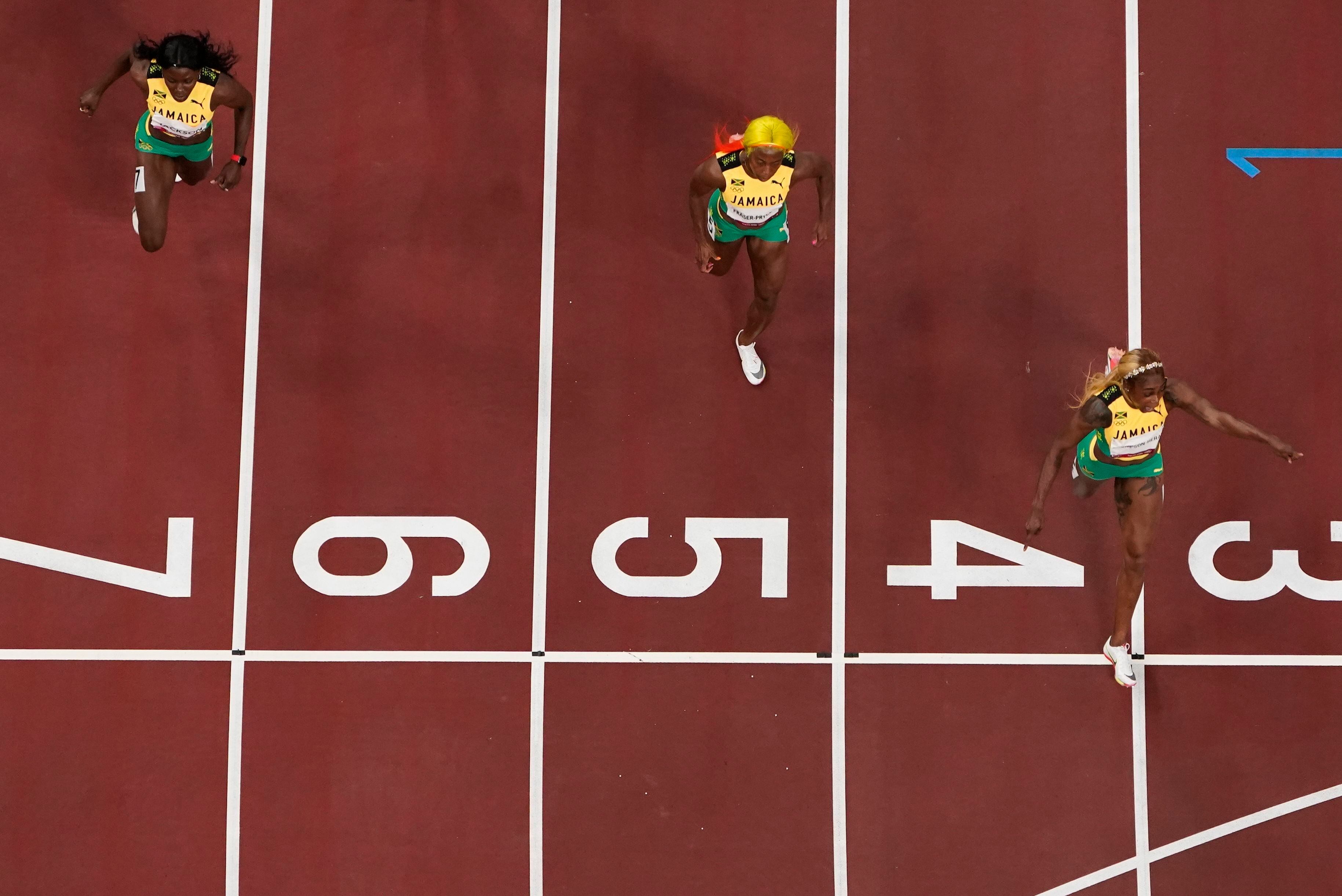 Las tres jamaicanas cruzan la meta en la final de los 100m esta tarde en el Estadio Olímpico de Tokio. 
