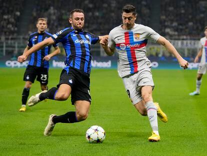 Robert Lewandowski pelea el balón con Stefan de Vrij en el duelo entre el Inter y el Barcelona.