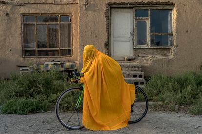 Algo tan simple como montar en bicicleta está prohibido para las mujeres en Afganistán. Mucho menos practicar ciclismo de manera profesional. Con su llegada al poder, los talibanes han alejado a las mujeres de parques y gimnasios. En la imagen, una afgana posa junto a su bicicleta ocultando su identidad.