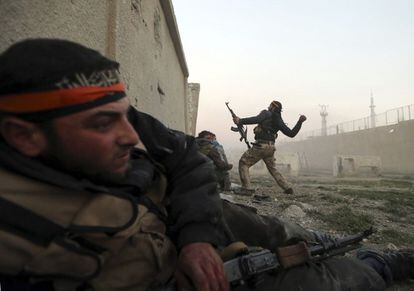 Un combatiente del ejercito sirio libre lanza una granada dentro de el recinto del ejercito sirio en Arabeen
