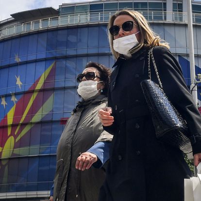 Skopje (Republic Of North Macedonia), 07/05/2020.- Women wearing protective masks walk in front of the EU office decorated with Macedonia and EU flags and their logo 'EU for You' in Skopje, Republic of North Macedonia, 07 May 2020. At the European Union-Western Balkan summit on 06 May, EU leaders confirmed unequivocal support to the Western Balkan countries regarding the COVID-19 pandemic. They agreed on giving 3.3 billion euros to help these countries with recovering from the economic crisis. EFE/EPA/GEORGI LICOVSKI