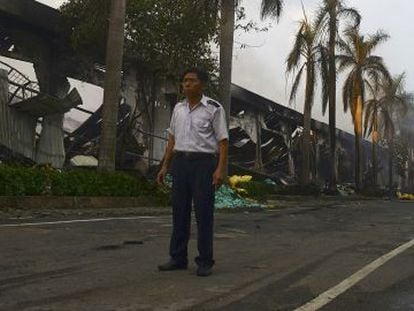 Un vigilante custodia una f&aacute;brica china que ardi&oacute; en los disturbios de Binh Duong (Vietnam).