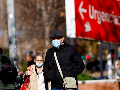 Personas con  mascarillas caminan en el entorno de un centro sanitario en Madrid a principios de enero.