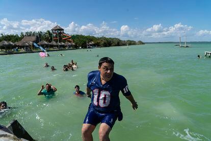 A group of tourists bathes in the Bacalar lagoon.