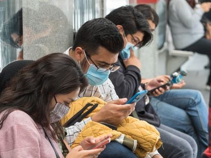 Un grupo de personas utiliza sus teléfonos móviles, en una estación del Metrobús de Ciudad de México, en una imagen de archivo.