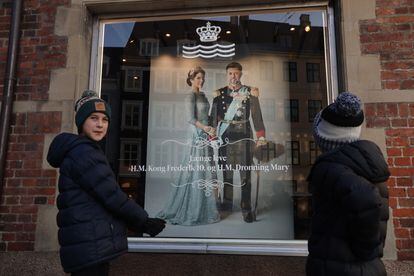 Dos niños australianos observan el retrato de los futuros reyes daneses, Federico y María, en el centro de Copenhague. 