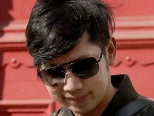 FILE - In this April 5, 2017, file photo, Vorayuth "Boss" Yoovidhya, whose grandfather co-founded energy drink company Red Bull, leaves a house in London. Interpol, the France-based international police cooperation agency, has issued a "Red Notice" for the apprehension of Vorayuth who was involved in a 2012 traffic accident in Bangkok that killed a motorcycle police officer, authorities in Thailand said Monday. (AP Photo/Matt Dunham, File)