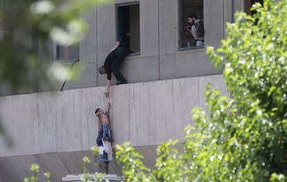 Un niño es evacuado durante el ataque al Parlamento en Teherán (Iran).