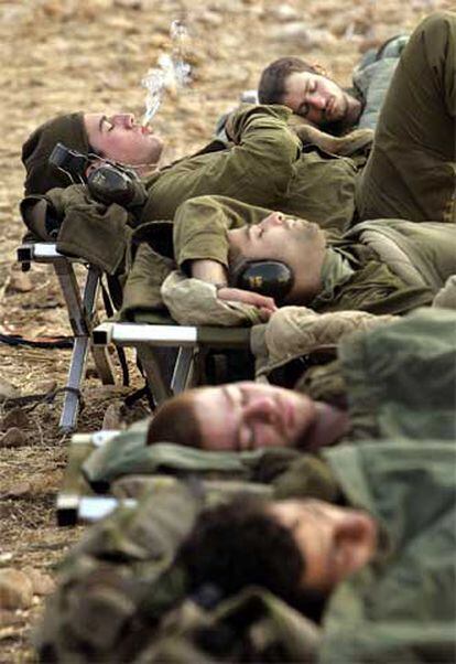 Soldados israelíes descansan en su puesto de artillería en la frontera con Líbano.