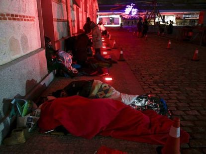 Varias personas descansan en el suelo en el espacio cultural Matadero. 