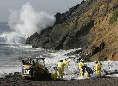 Trabajadores del servicio de medio ambiente de EE UU limpian de restos de petróleo la playa californiana de Rodeo.