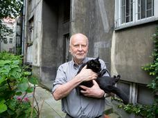 El escritor Adam Zagajewski, en su casa en Cracovia en 2017 , con su gato 'Doncia'.