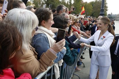 La princesa Leonor saluda y se fotografía con las personas congregadas en la Plaza de Oriente de Madrid.