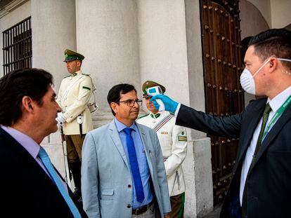Un agente controla la temperatura a las puertas de La Moneda, sede del Gobierno chileno.