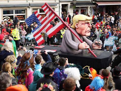 DUSSELDORF, GERMANY - FEBRUARY 12: A parade float shows an effigy of Donald Trump holding a pair of scissors in his hand with a cut-up US flag in the shape of a swastika at the annual Rose Monday Carnival parade on February 12, 2024 in Dusseldorf, Germany. The Mainz and Dusseldorf Rose Monday parades are known for their biting political satire. Cities in western Germany are celebrating the traditional Rhineland Carnival this week, culminating in today's Rose Monday parades. (Photo by Andreas Rentz/Getty Images)