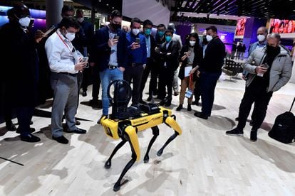 Visitors take pictures of Boston Dynamics' SPOT robot dog on the opening day of the MWC (Mobile World Congress) in Barcelona on February 28, 2022.