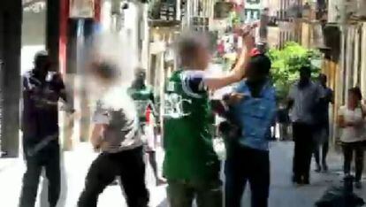 Un momento del vídeo publicado por 'Abc' en el que el agente de la camiseta verde, en primer plano, tiene la pistola en la mano.