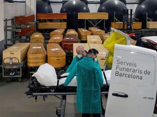 Funeral workers transferring the remains of a Covid-19 victim in Barcelona.