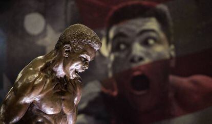 Una estatua de Ali frente a una imagen del púgil, en una exposición.