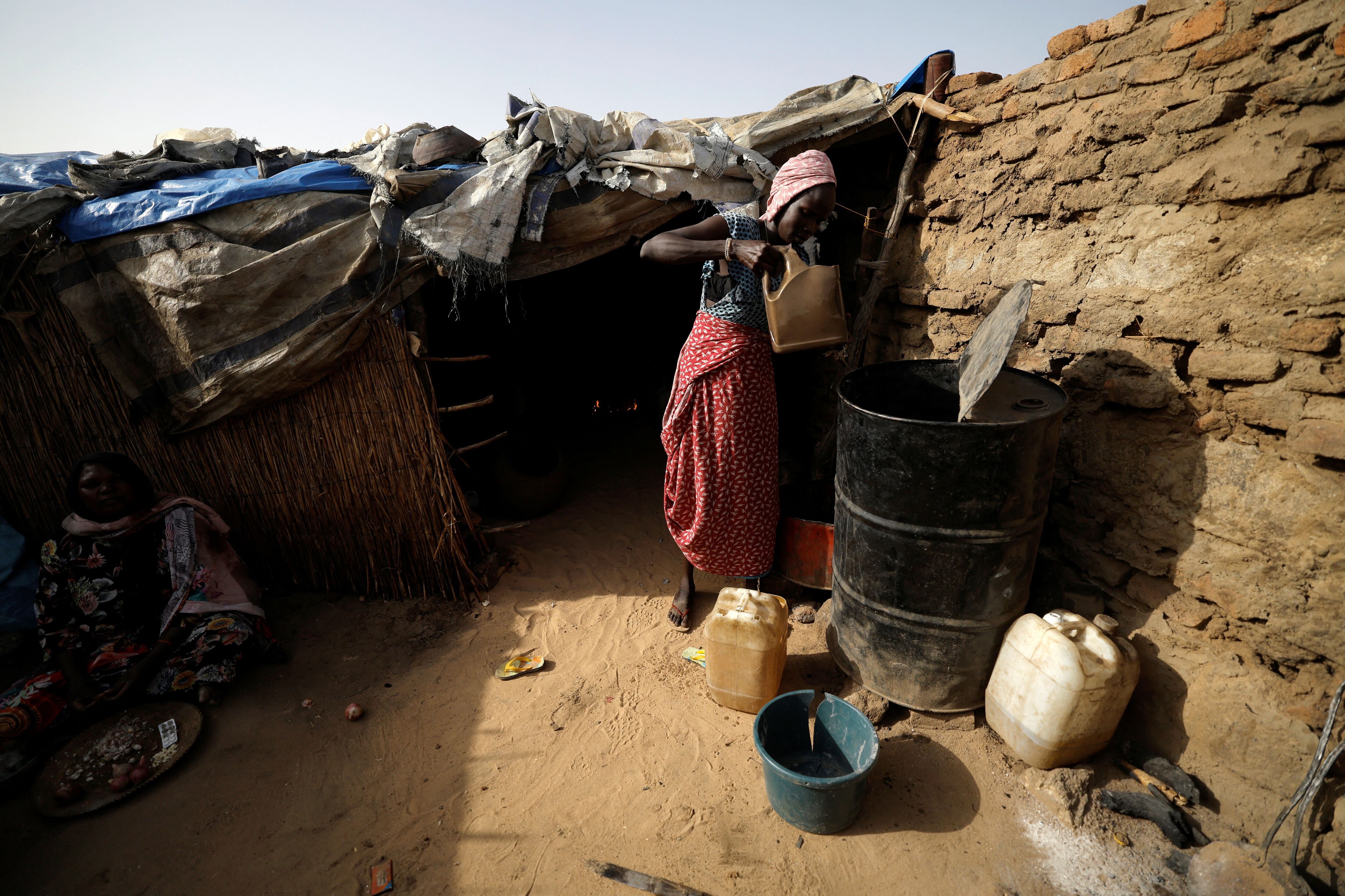 Kazwa, sudanesa de 23 años que huyó de la violencia en Darfur, toma agua en la casa de una familia chadiana, donde se refugia, en Koufroun, cerca de la frontera entre Sudán y Chad, el 14 de mayo de 2023. 