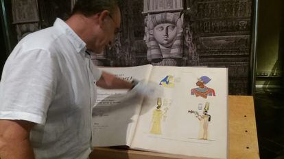 El conservador del Museu Egipci Luis Manuel Gonzálvez muestra uno de los libros de la exposición.