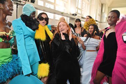 Designer Harris Reed (center, applauding) poses with her bodice backstage at the Nina Ricci show on March 3, 2023 in Paris.