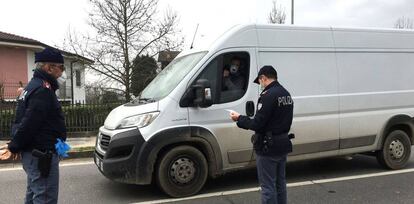 Dos operarios de la Policía Local italiana hacen guardia este martes en uno de los puestos de control para entrar en un municipio en cuarentena en la