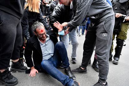 Un manifestante herido durante las protestas de este jueves en Atenas intenta levantarse del suelo.