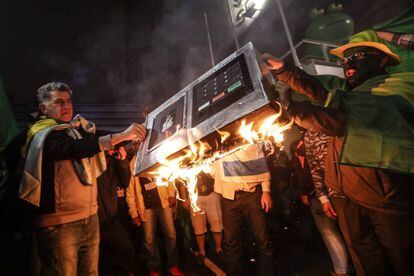Simpatizantes del candidato presidencial Jair Bolsonaro queman una urna electrónica en la avenida Paulista en Sao Paulo (Brasil)