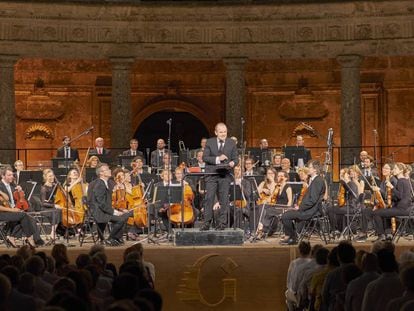 François-Xavier Roth se dirige al público al final del concierto con su orquesta Les Siècles en el Palacio de Carlos V.