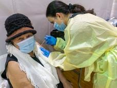 FILE - In this Jan. 31, 2021, file photo, registered Nurse Rita Alba gives a patient the first dose of the coronavirus vaccine at a pop-up COVID-19 vaccination site at the Bronx River Community Center in the Bronx borough of New York. The deadliest month of the coronavirus outbreak in the U.S. drew to a close with certain signs of progress: COVID-19 cases and hospitalizations are trending downward, while vaccinations are picking up speed. (AP Photo/Mary Altaffer, File)