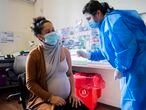 A nurse gives a shot of the Pfizer vaccine for COVID-19 to a pregnant woman in Montevideo, Uruguay, Wednesday, June 9, 2021. (AP Photo/Matilde Campodonico)