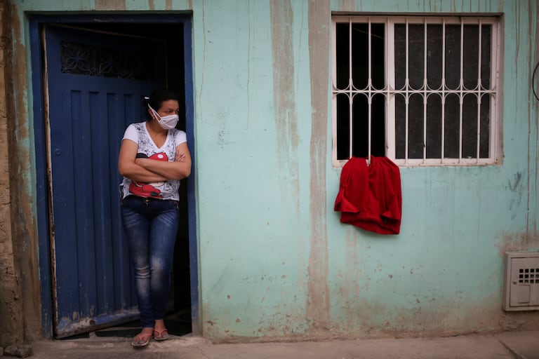 A woman awaits the arrival of social benefits in Bogotá, on April 20, 2020.