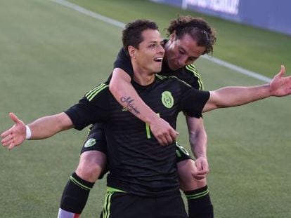 Chicharito Hernández es abrazado por Guardado en una partido de la selección mexicana.