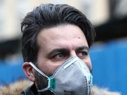 Un hombre iraní porta una máscara protectora para tratar de evitar contagiarse por el coronavirus mientras camina por el Gran Bazar de Teherán, Irán.