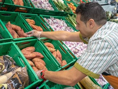 Un empleado, en la sección de fruta de un supermercado Mercadona.