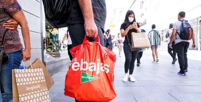 Varias personas caminan por el centro de Madrid con bolsas de compras en varios establecimientos de la capital.