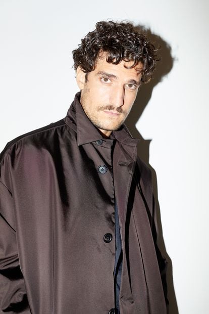 Louis Garrel poses for ICON in San Sebastian with a Prada coat.