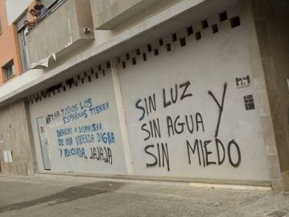 Pintada en los bajos de un bloque ocupado de viviendas en Sevilla.