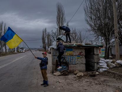 Ukrainian children play at an abandoned checkpoint in Kherson, southern Ukraine, Wednesday, Nov. 23, 2022. A new onslaught of Russian strikes on Ukrainian infrastructure on Wednesday caused power outages across the country — and in neighboring Moldova — further hobbling Ukraine's battered electricity network and compounding civilians' misery as winter advances. (AP Photo/Bernat Armangue)