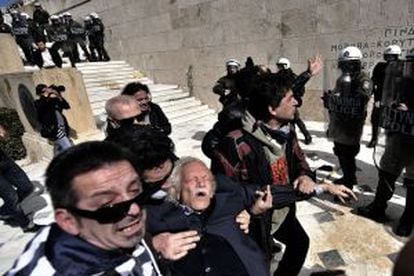 Manolis Glezos es auxiliado tras ser golpeado por la policía durante una protesta en marzo de 2010 en Atenas