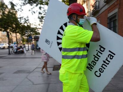 Un operario retira una de las señales de Madrid Central.