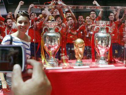 Una seguidora de La Roja posa con los trofeos.