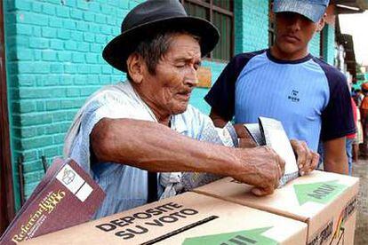 En la imagen, un campesino boliviano deposita su voto en una urna de cartón.