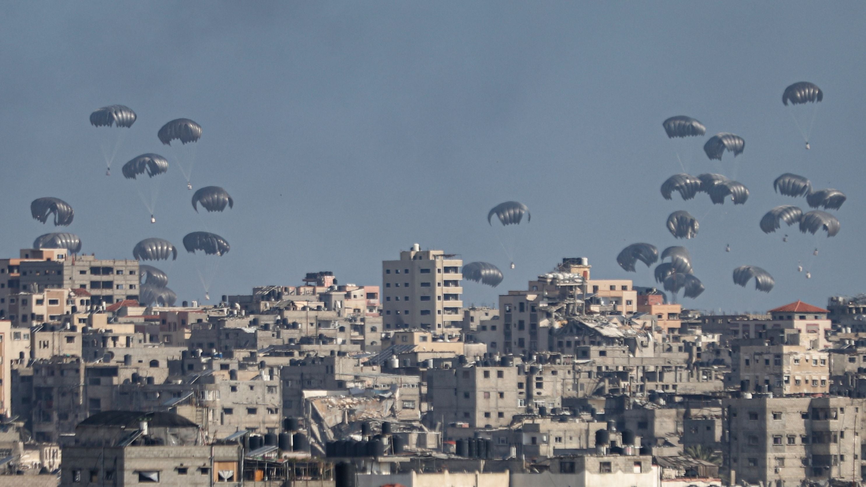 GAZA CITY, GAZA - APRIL 11: Humanitarian aid packages are seen landing by the help of parachutes after dropping from a plane as Israeli attacks continue on the second day of Eid al-Fitr in Gaza City, Gaza on Arpil 11, 2024. (Photo by Dawoud Abo Alkas/Anadolu via Getty Images)