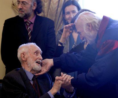 El actor Héctor Alterio saluda cariñosamente al escritor y economista José Luis Sampredro durante el homenaje que le tributó el Ministerio de Cultura en la Biblioteca Nacional, con motivo de la concesión de la Medalla de las Artes y las Letras de España, en 2011.
