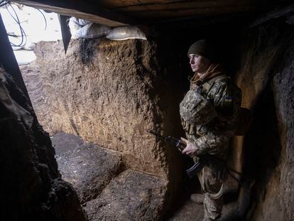 A Ukrainian soldier stands in the trench on the line of separation from pro-Russian rebels, Mariupol, Donetsk region, Ukraine, Thursday, Jan. 20, 2022. President Joe Biden has warned Russia's Vladimir Putin that the U.S. could impose new sanctions against Russia if it takes further military action against Ukraine. U.S. Secretary of State Antony Blinken is warning of a unified, "swift, severe" response from the United States and its allies if Russia sends any military forces into Ukraine. (AP Photo/Andriy Dubchak)